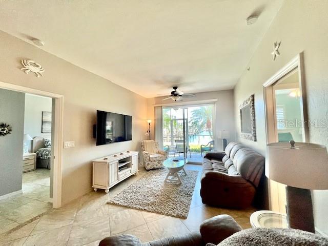 2060 Matecumbe Key Road, Unit 2102 Punta Gorda, FL 33955 - Photo 12 of 51 a living room with furniture and a flat screen tv