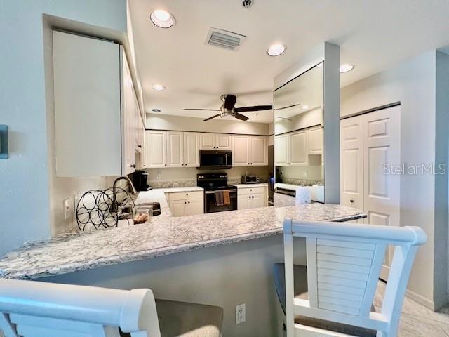 2060 Matecumbe Key Road, Unit 2102 Punta Gorda, FL 33955 - Photo 15 of 51 a kitchen with granite countertop a sink stainless steel appliances and cabinets