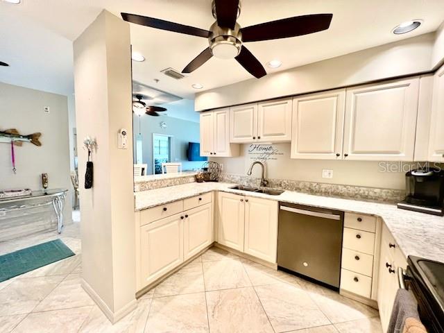2060 Matecumbe Key Road, Unit 2102 Punta Gorda, FL 33955 - Photo 16 of 51 a kitchen with stainless steel appliances granite countertop a sink window and cabinets