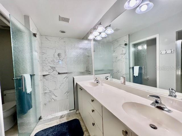 2060 Matecumbe Key Road, Unit 2102 Punta Gorda, FL 33955 - Photo 25 of 51 a bathroom with a double vanity sink mirror and shower