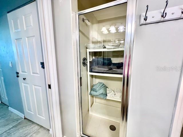 2060 Matecumbe Key Road, Unit 2102 Punta Gorda, FL 33955 - Photo 27 of 51 a bathroom with a glass shower door and a window