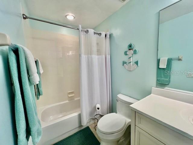 2060 Matecumbe Key Road, Unit 2102 Punta Gorda, FL 33955 - Photo 32 of 51 a white toilet sitting next to a bathroom sink and a shower