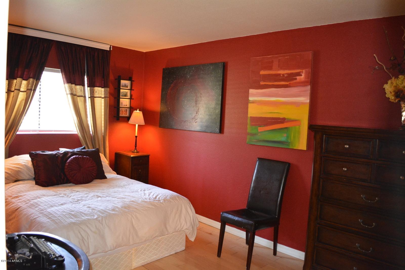 5401 East Thomas Road, Unit 1032 Phoenix, AZ 85018 - Photo 18 of 34 a bedroom with a bed and wooden floor