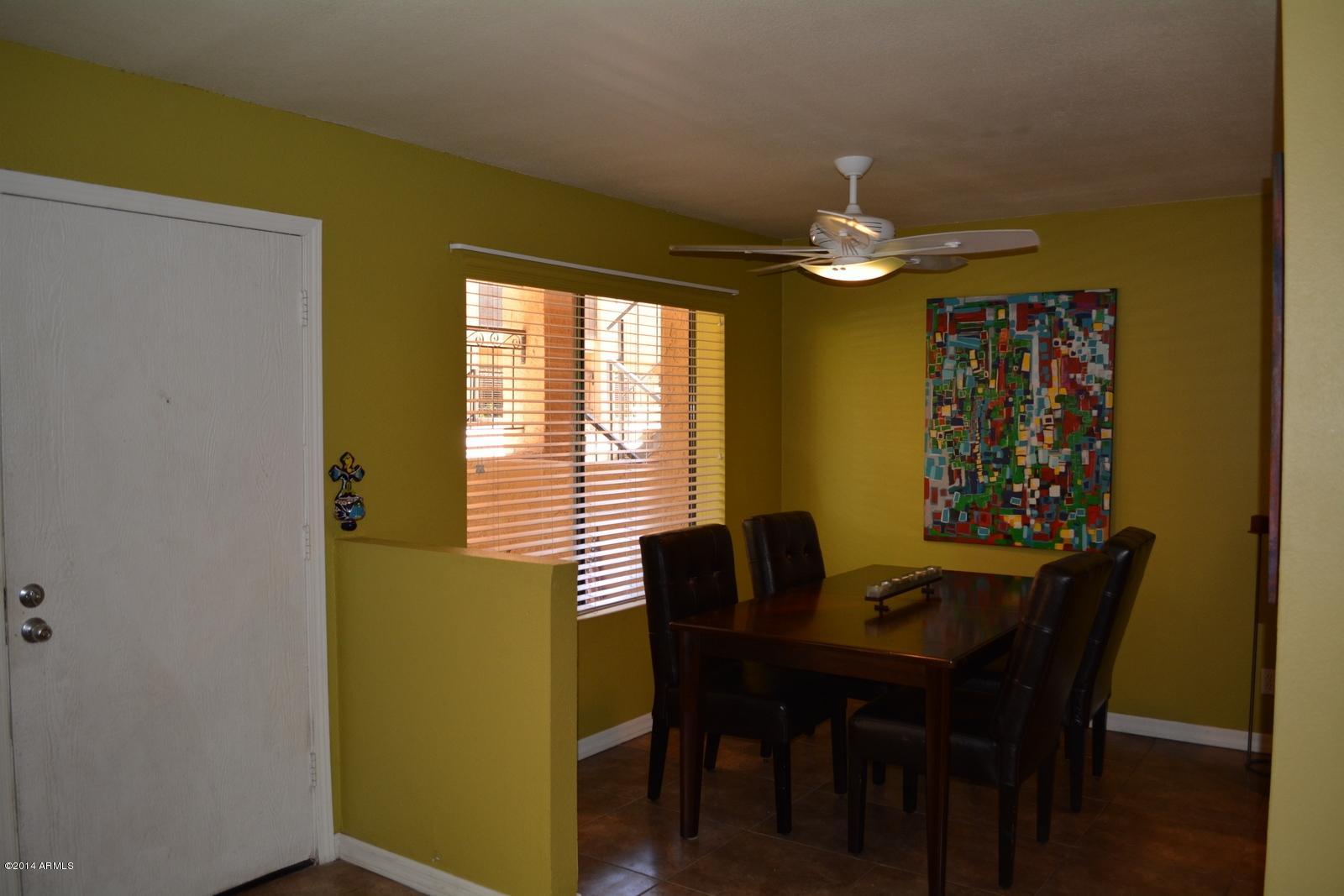 5401 East Thomas Road, Unit 1032 Phoenix, AZ 85018 - Photo 25 of 34 a dining room with furniture and chandelier fan
