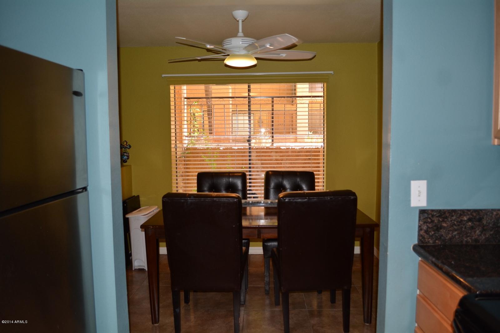 5401 East Thomas Road, Unit 1032 Phoenix, AZ 85018 - Photo 26 of 34 a view of a dining room with furniture and a chandelier