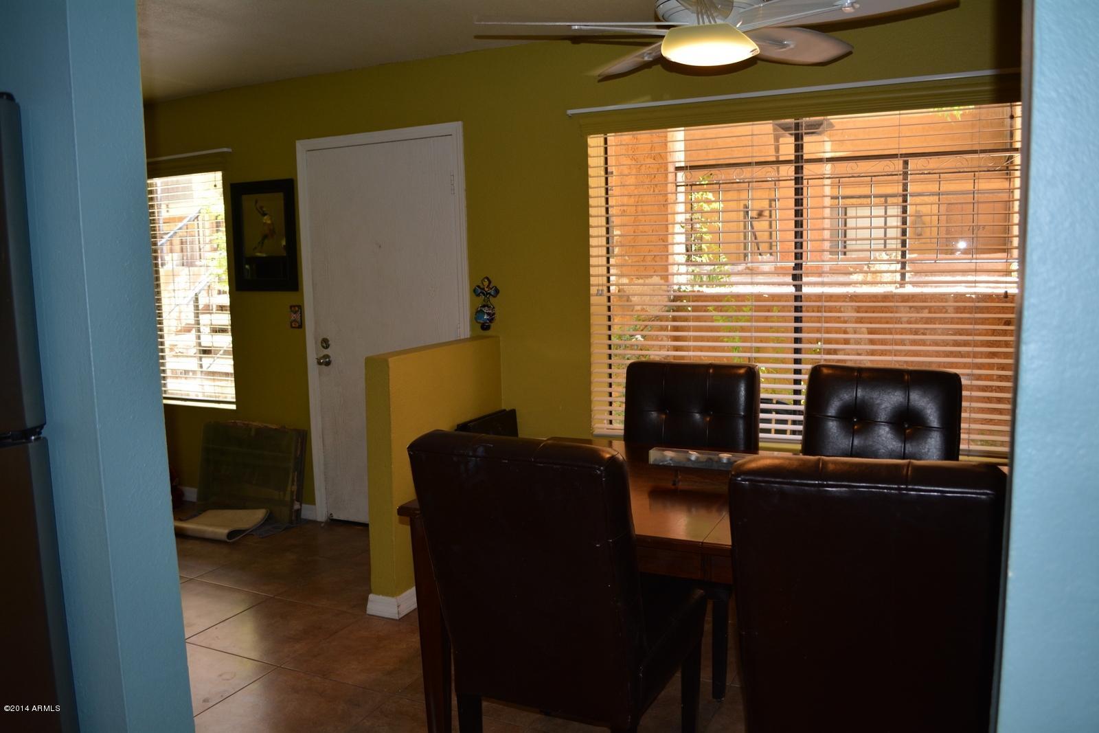 5401 East Thomas Road, Unit 1032 Phoenix, AZ 85018 - Photo 27 of 34 a living room with furniture and a fireplace