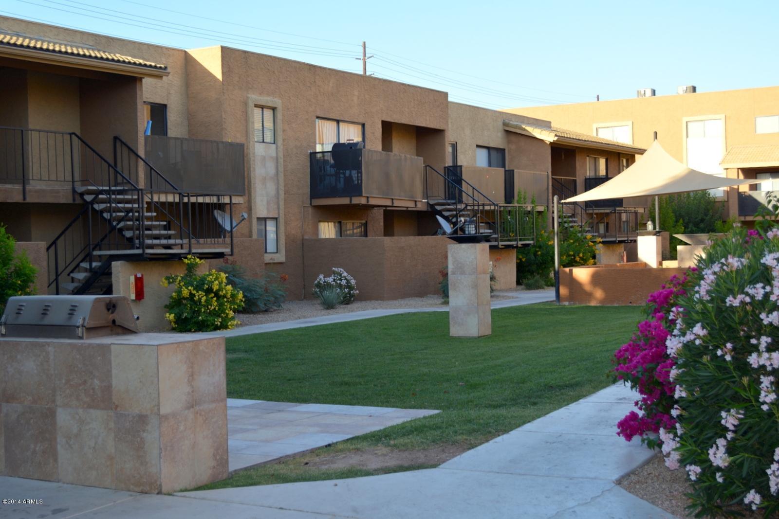 5401 East Thomas Road, Unit 1032 Phoenix, AZ 85018 - Photo 31 of 34 a front view of a house with a yard and a garden