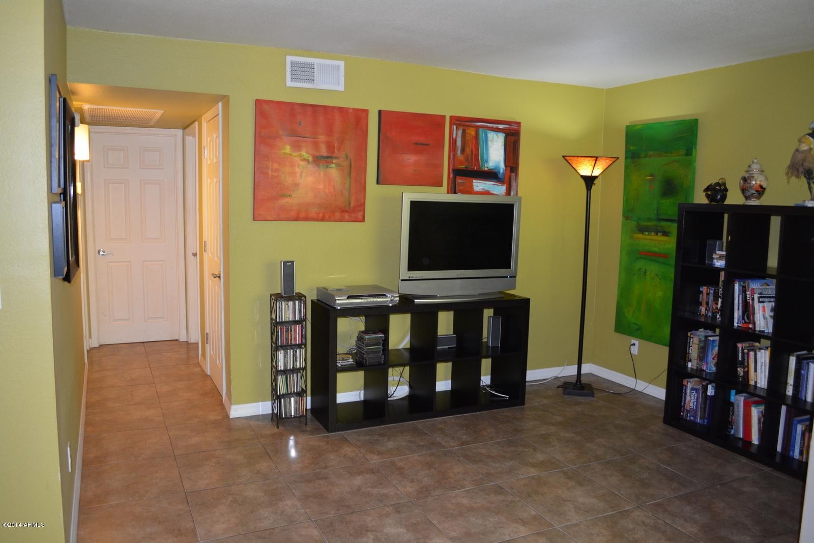 5401 East Thomas Road, Unit 1032 Phoenix, AZ 85018 - Photo 6 of 34 a living room with furniture and a flat screen tv