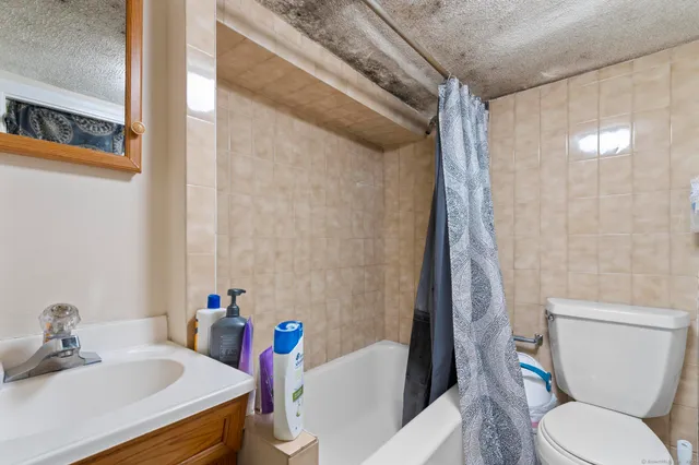 a bedroom with bed and a chandelier