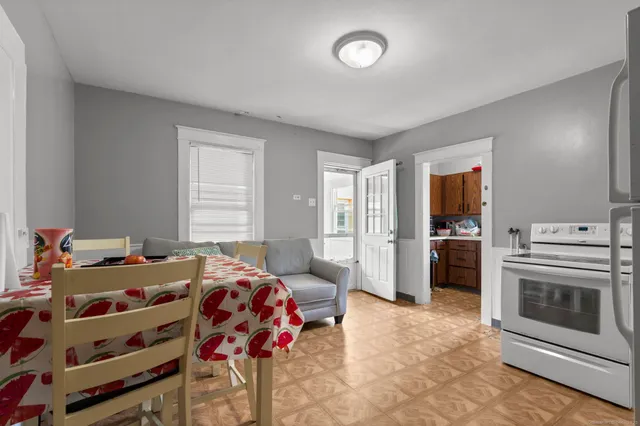 a kitchen with stainless steel appliances granite countertop a sink window and cabinets