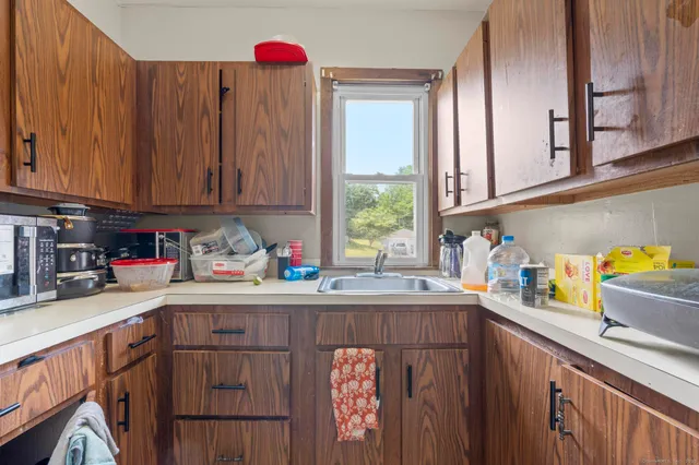 a view of a livingroom with lounge chair and a window