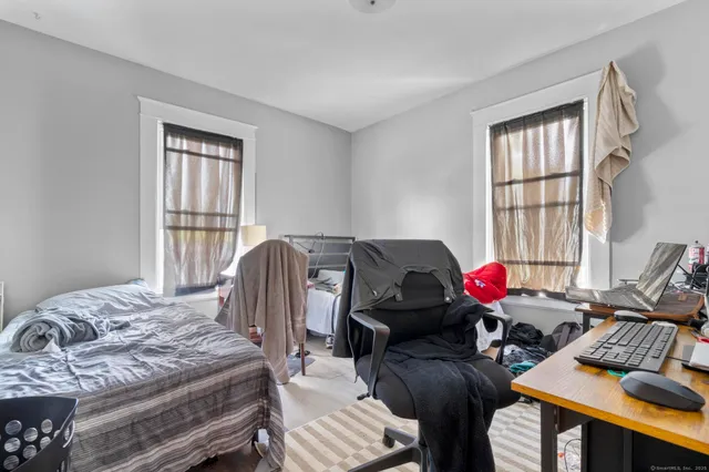 a bedroom with bed and dresser