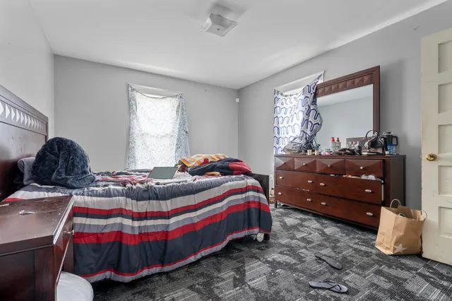 a bedroom with bed and window