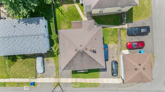 an aerial view of multiple houses with yard