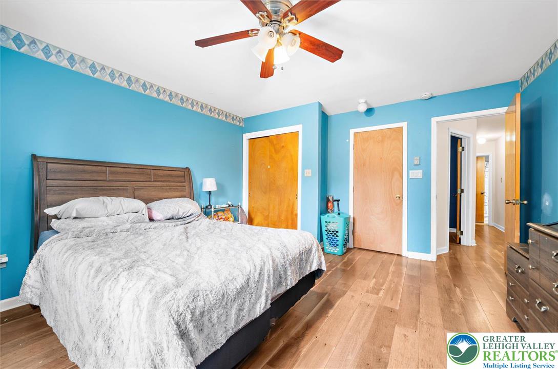 326 Chestnut Street Slatington, PA 18080 - Photo 13 of 28 a bedroom with a large bed and a chandelier