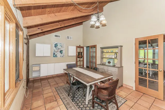 a large kitchen with kitchen island a large counter top space appliances and cabinets