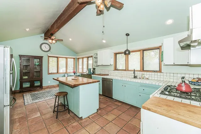 a kitchen with a sink cabinets and wooden floor