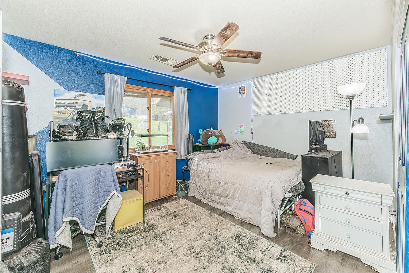 30240 Watts Valley Road Tollhouse, CA 93667 - Photo 25 of 65 a bedroom with a bed and wooden floor