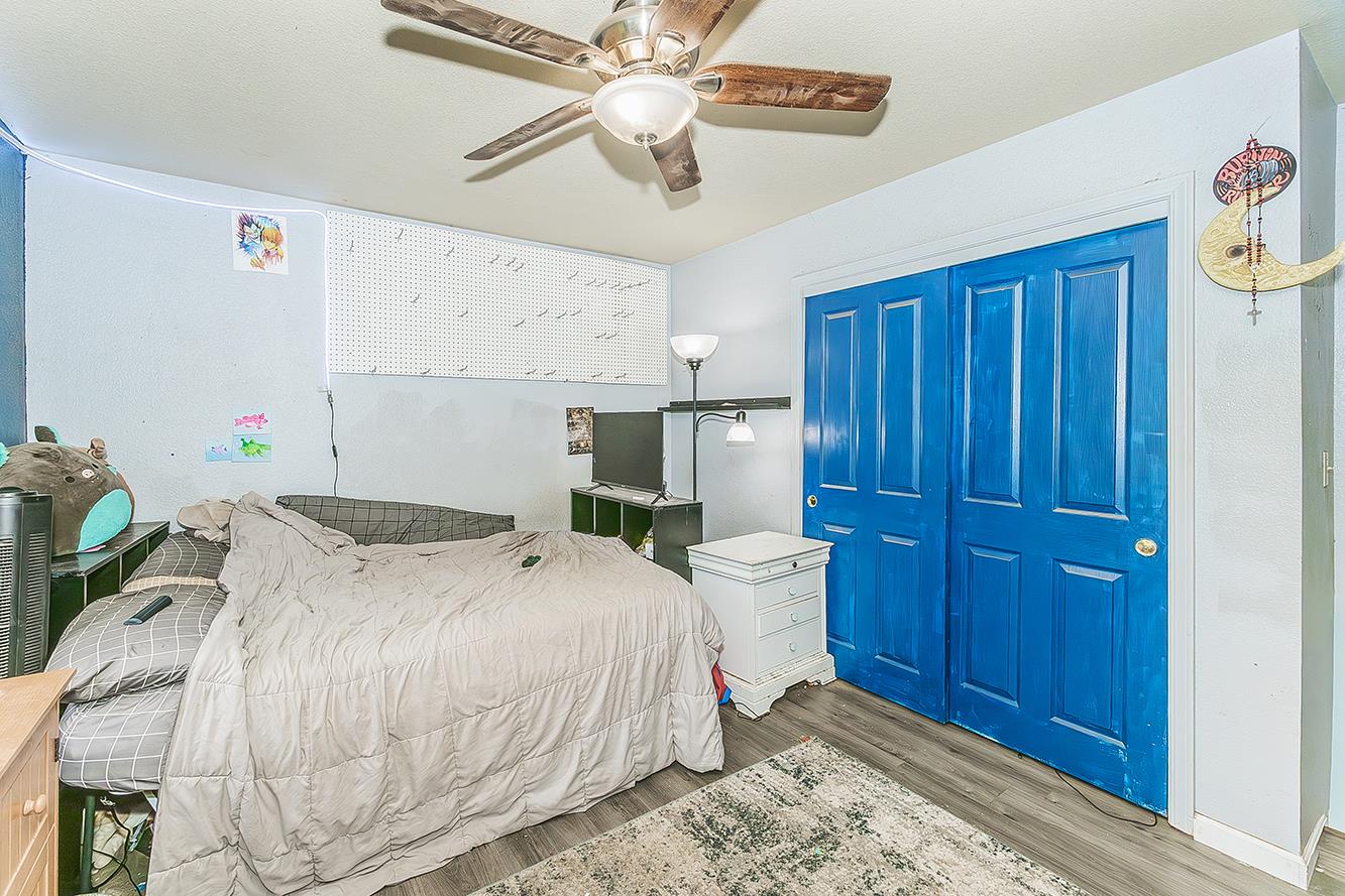 30240 Watts Valley Road Tollhouse, CA 93667 - Photo 26 of 65 a bedroom with a bed and a chandelier