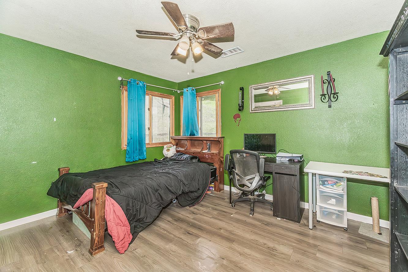 30240 Watts Valley Road Tollhouse, CA 93667 - Photo 27 of 65 a bedroom with a bed and a table in it