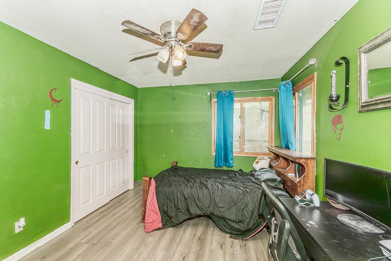 30240 Watts Valley Road Tollhouse, CA 93667 - Photo 29 of 65 a bedroom with a bed and a large window