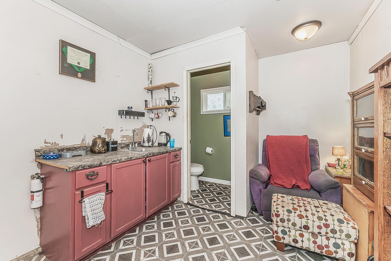 30240 Watts Valley Road Tollhouse, CA 93667 - Photo 41 of 65 a bathroom with a granite countertop toilet a sink and a mirror