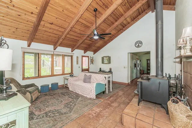 a living room with furniture a couch and large window