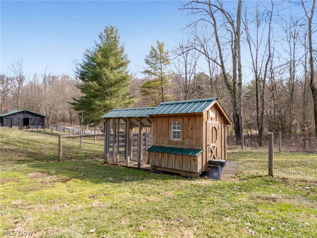 2210 Scroll Road Southwest Carrollton, OH 44615 - Photo 32 of 48 View of chicken coop featuring view of wooded area