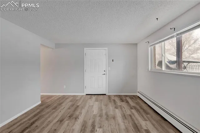 a view of a room with wooden floor and windows