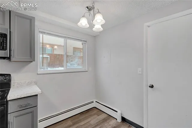 a view of wooden floor and cabinets in a room