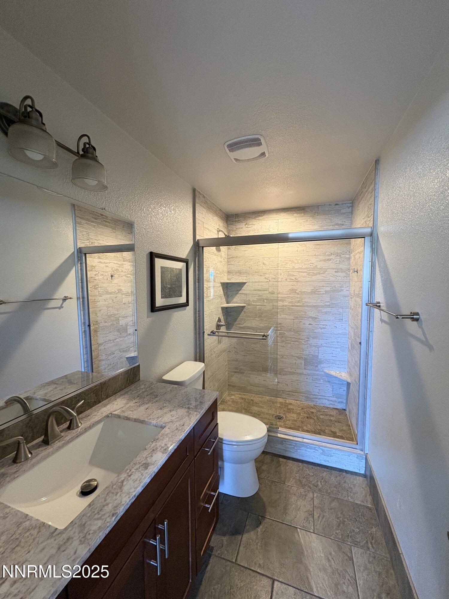 2000 Royal Drive Reno, NV 89503 - Photo 19 of 33 a bathroom with a sink granite countertop toilet a mirror and a shower