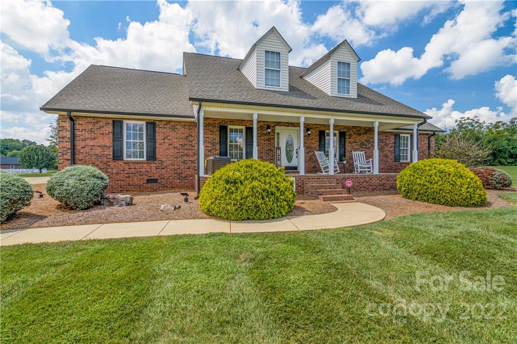 a front view of a house with a yard and porch