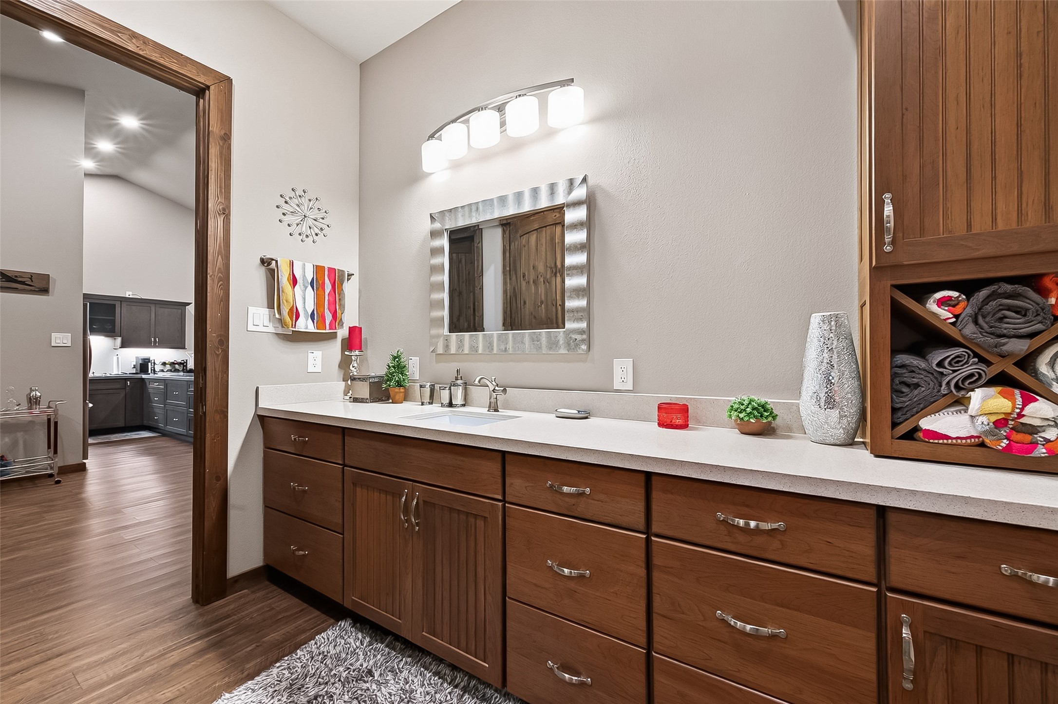 22610 Cessna Road Needville, TX 77461 - Photo 24 of 37 Stylish bathroom featuring wood accents, a modern vanity with ample storage, and a unique wall decor piece adding a touch of elegance.