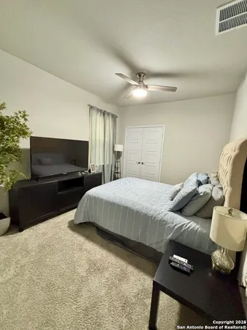 a bedroom with a bed and a television