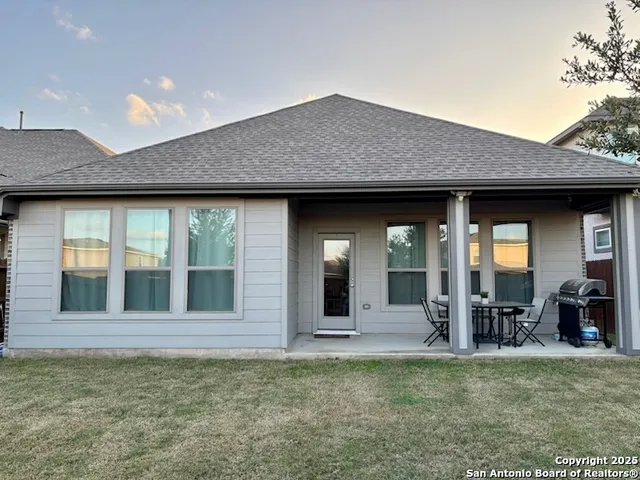 a view of a house with porch and chairs
