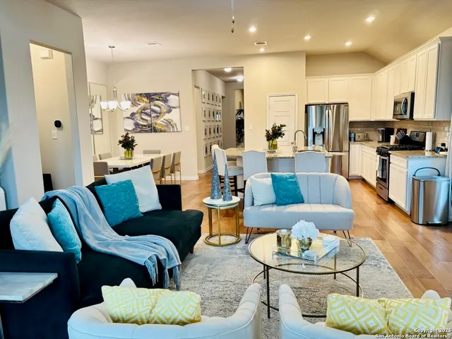 a living room with furniture kitchen view and a table