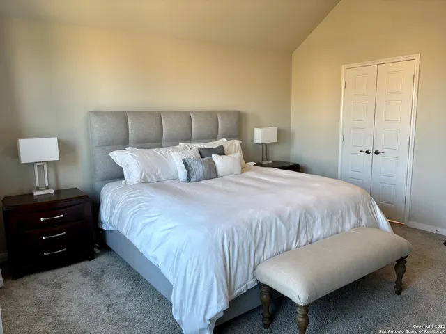 a bedroom with a bed and a lamp