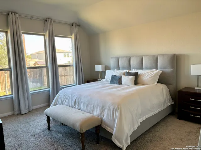 a bedroom with a bed and a large window