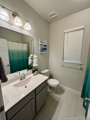 a bathroom with a sink toilet and mirror