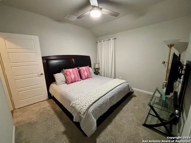 a bed sitting in a bedroom next to a window