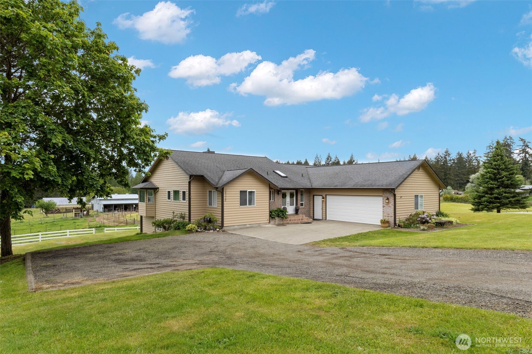14110 Glenwood Road Southwest Port Orchard, WA 98367 - Photo 2 of 40 a front view of a house with a garden and yard