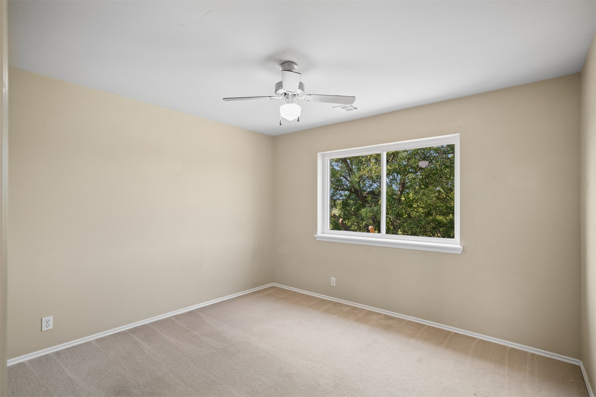175 Alt 75 Mounds, OK 74047 - Photo 34 of 41 Neutral wall paint, carpet flooring, a ceiling fan with integrated lighting, and a window with white trim