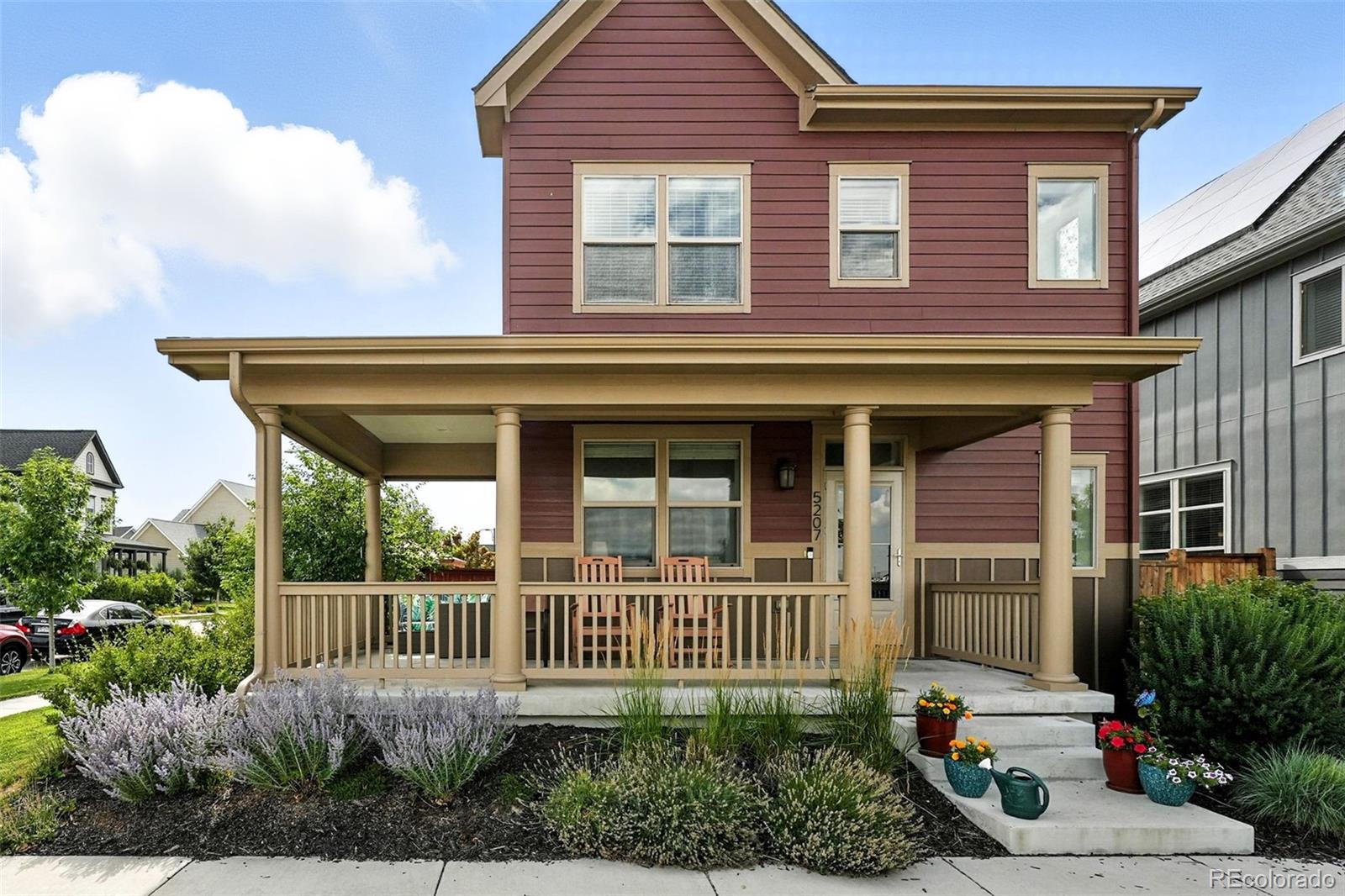 5207 Clinton Street Denver, CO 80238 - Photo 1 of 43 a front view of a house with a garden