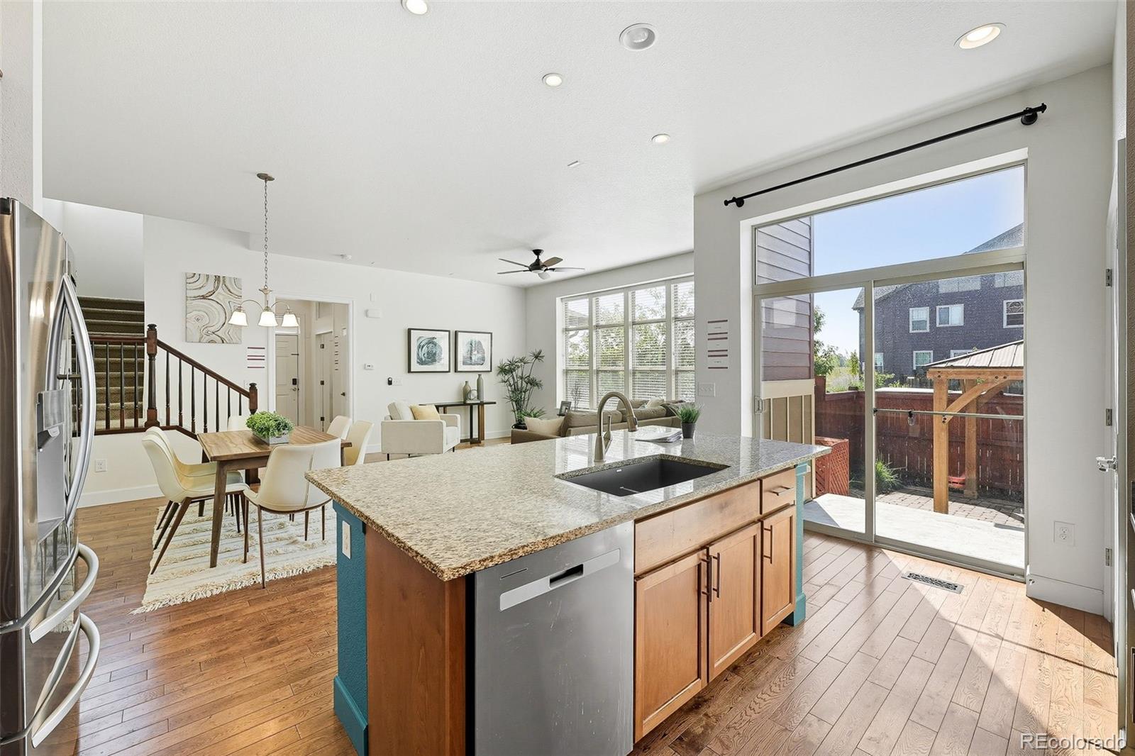 5207 Clinton Street Denver, CO 80238 - Photo 11 of 43 a kitchen with stainless steel appliances granite countertop a table and chairs