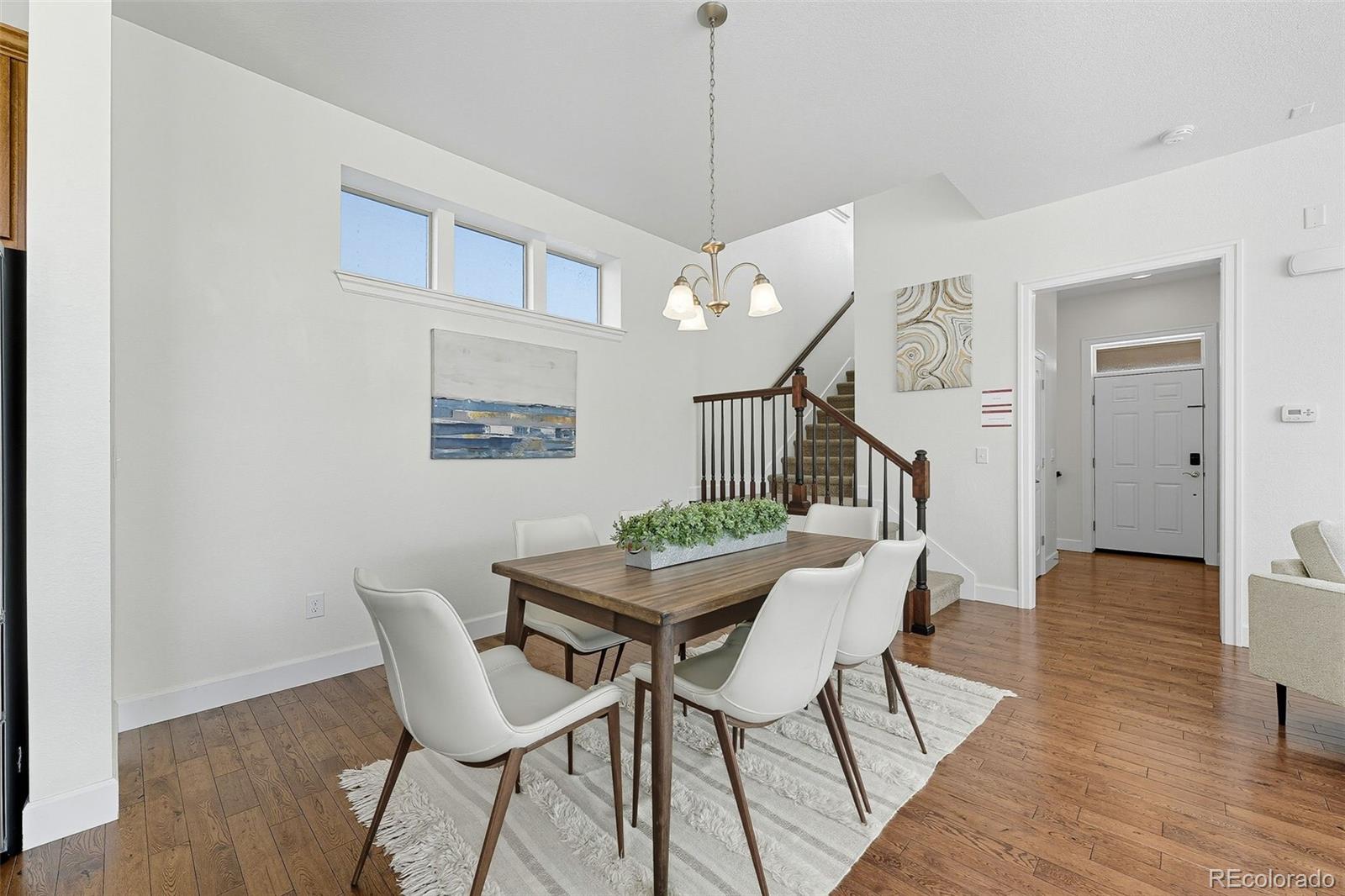 5207 Clinton Street Denver, CO 80238 - Photo 15 of 43 a dining room with furniture and wooden floor