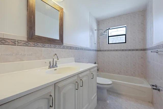 a bathroom with a sink a toilet and a bathtub