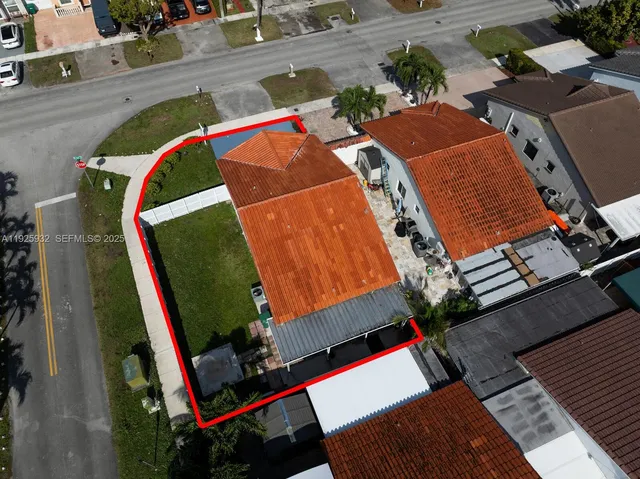 an aerial view of residential houses with city view