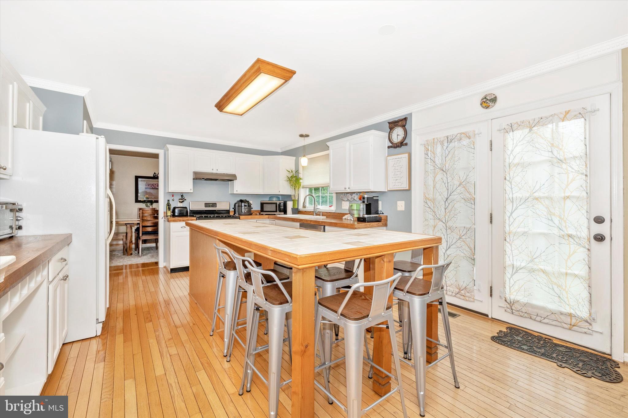 95 Burnside Court Frederick, MD 21702 - Photo 10 of 36 a kitchen with stainless steel appliances kitchen island granite countertop a stove a sink and a refrigerator