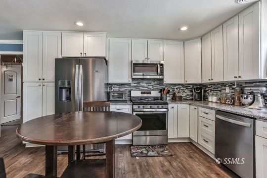 700 Sherri Street Ridgecrest, CA 93555 - Photo 2 of 34 a kitchen with stainless steel appliances a kitchen island microwave and cabinets