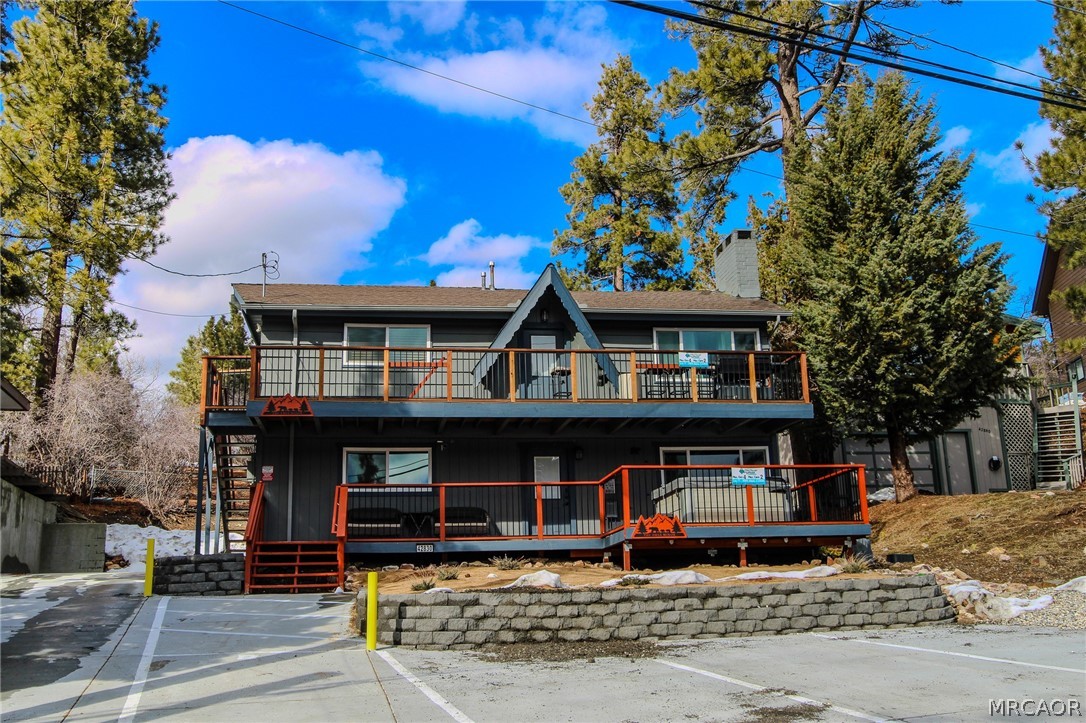 42830 Cougar Road, Unit UPPR Big Bear Lake, CA 92315 - Photo 1 of 21 a front view of a house with a garden
